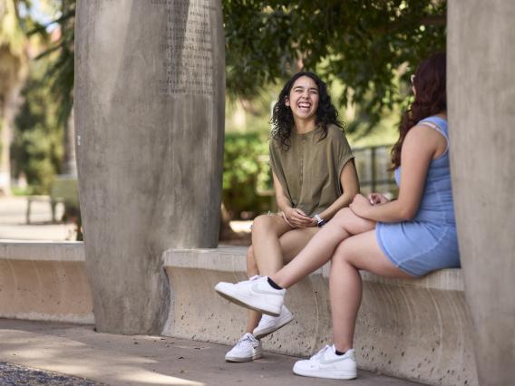 Two students talking at the Women's Plaza of Honor